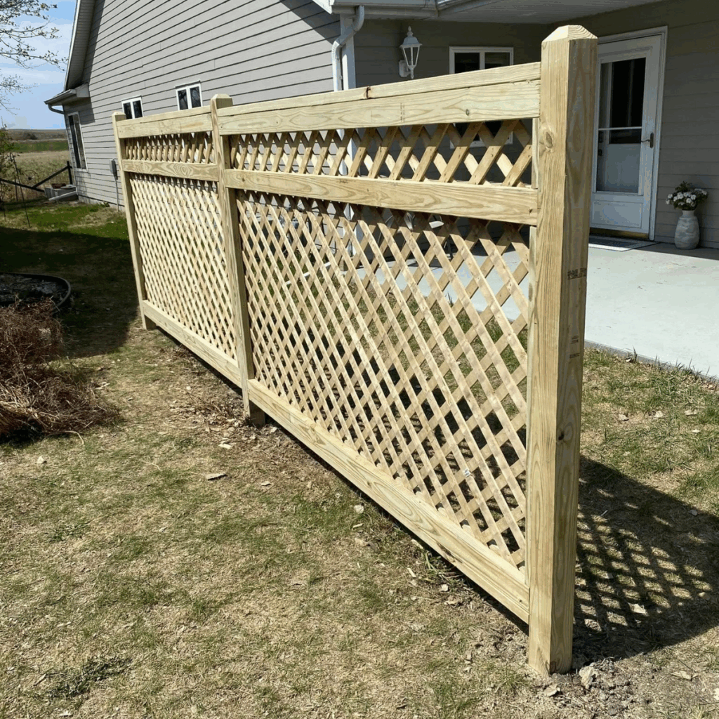 Custom lattice fence installation in Spirit Lake Iowa backyard